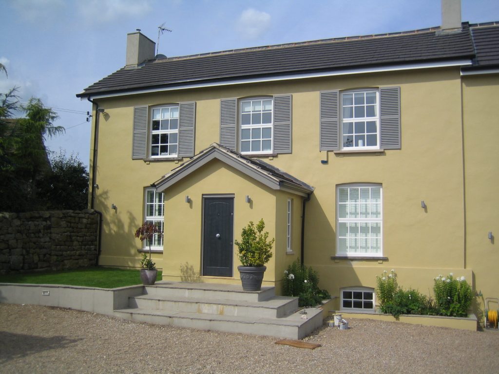 Yellow house with grey shutters 